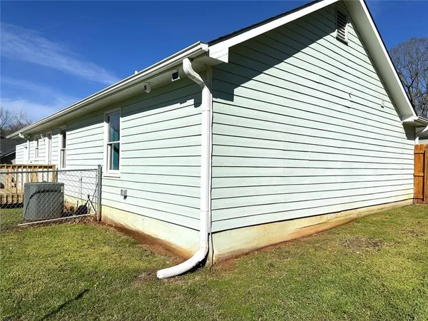 a view of a house with a yard and sitting area