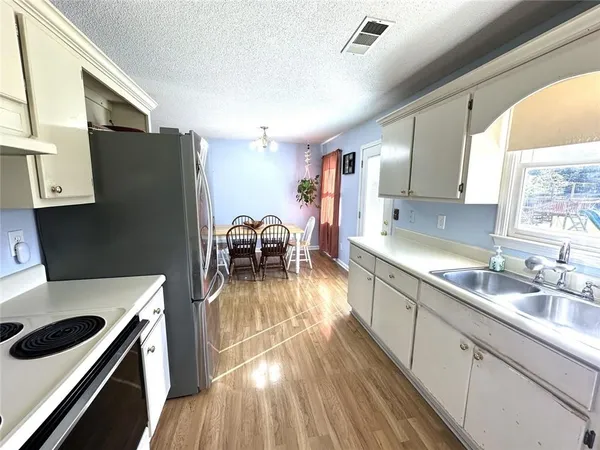 a kitchen with a sink a stove and cabinets