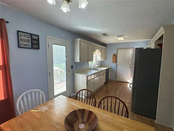 a kitchen with stainless steel appliances granite countertop a refrigerator a sink a stove and island