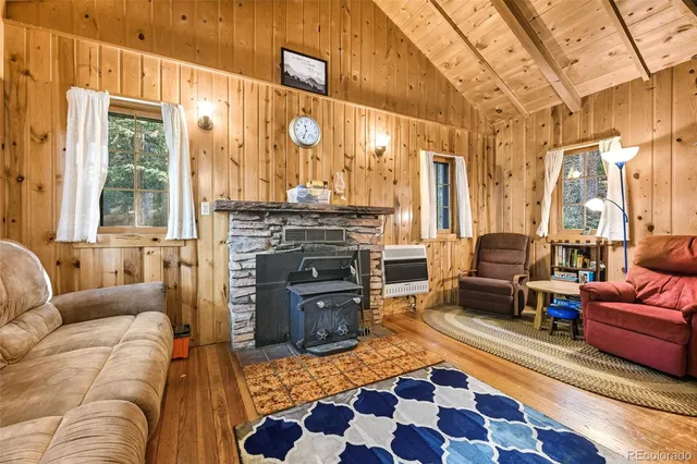 a living room with furniture a rug and a fireplace