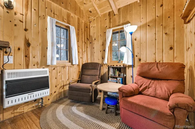a living room with furniture a couch and chandelier
