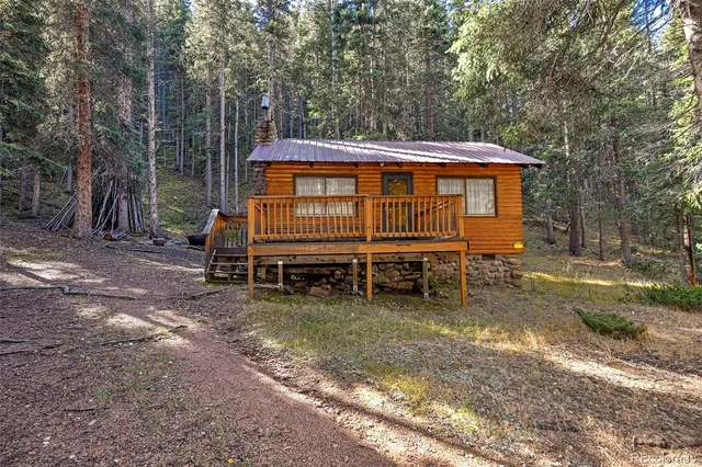 a view of a house with a yard chairs and a yard