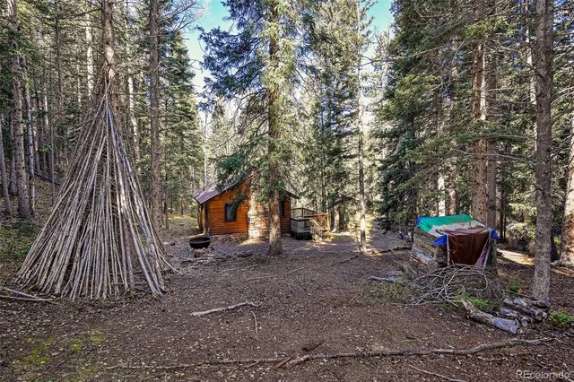 a backyard of a house with barbeque oven table and chairs