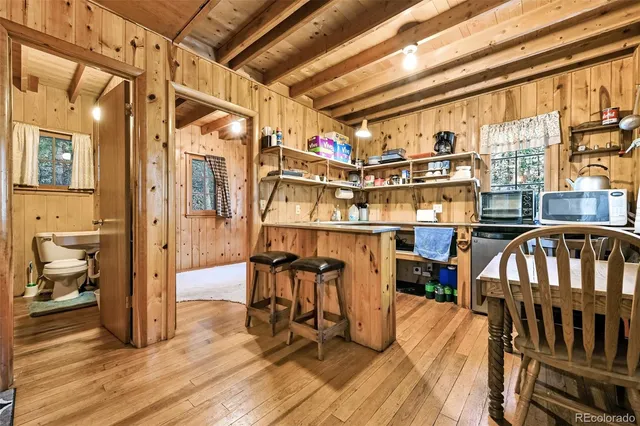 a view of a very nice looking room with wooden floor and furniture