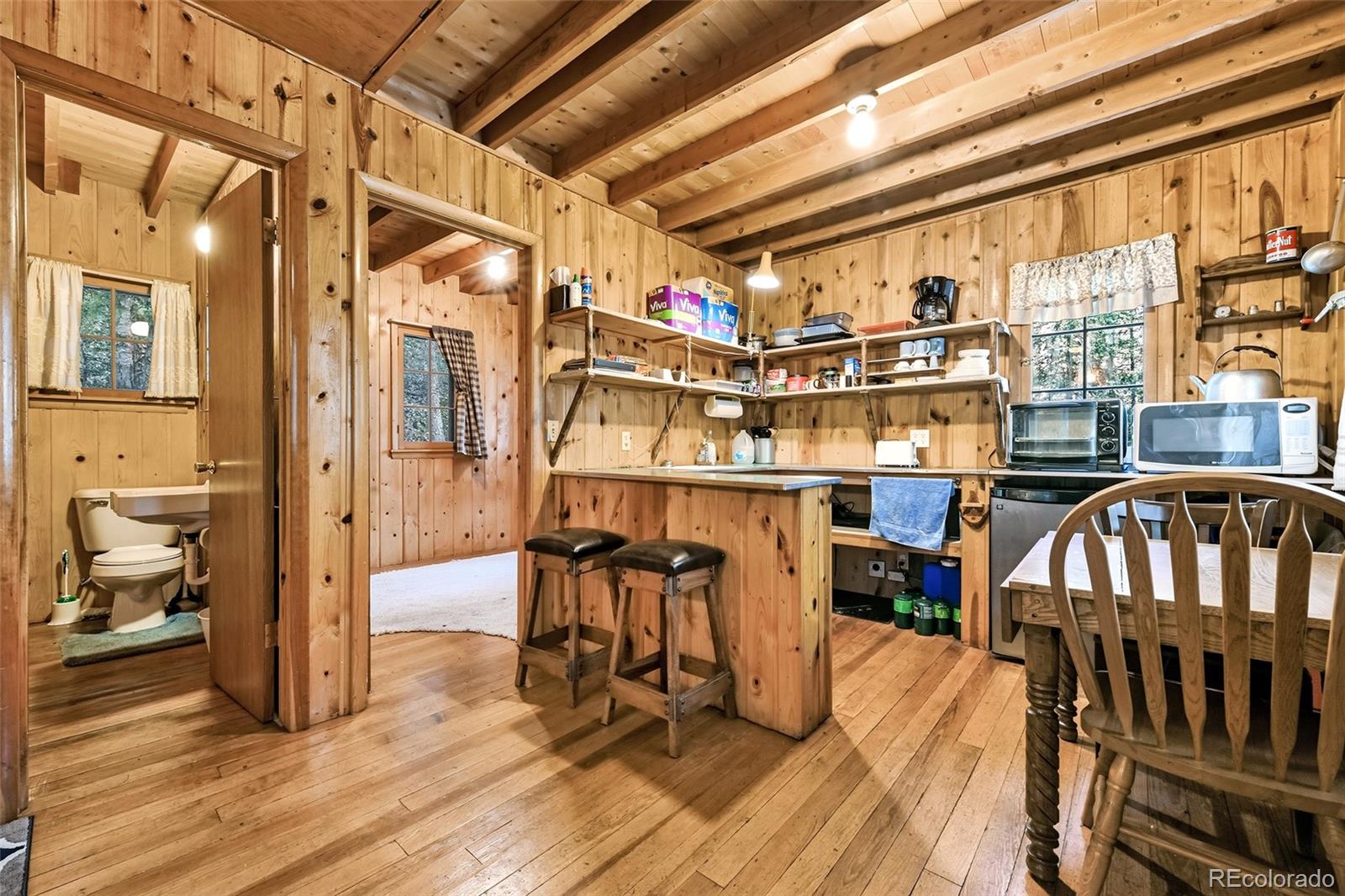 104 Usfs Divide, Unit 383 Divide, CO 80814 - Photo 4 of 41 a view of a very nice looking room with wooden floor and furniture