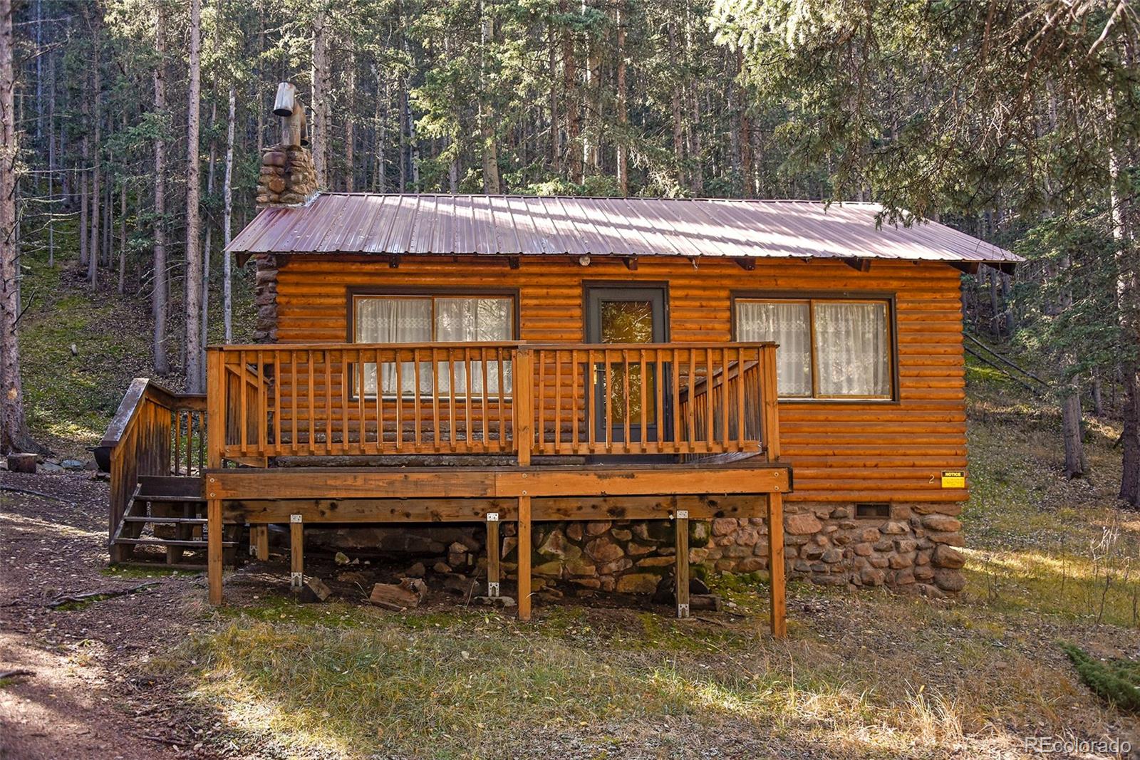 104 Usfs Divide, Unit 383 Divide, CO 80814 - Photo 41 of 41 a backyard of a house with barbeque oven wooden table and chairs