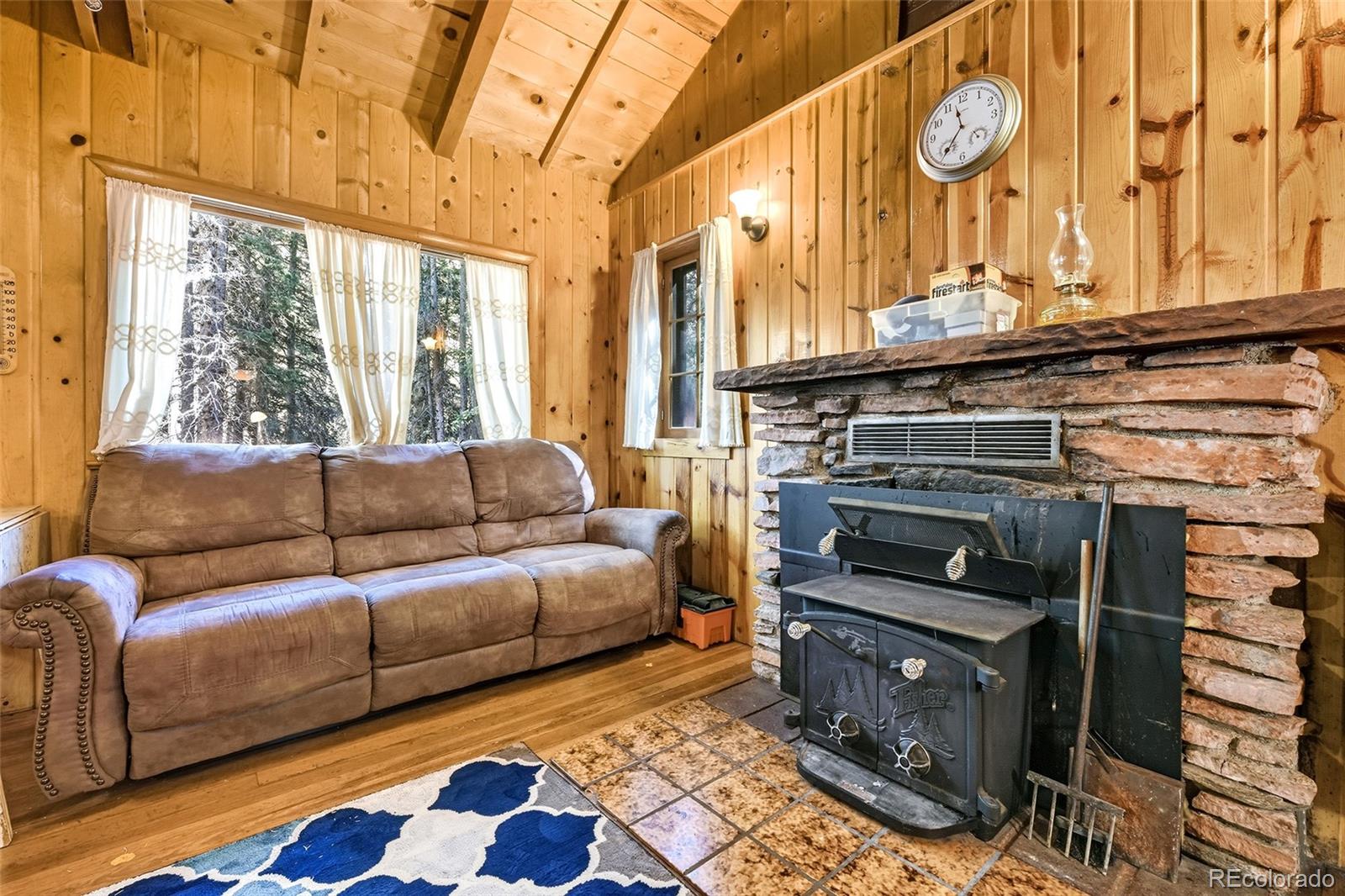 104 Usfs Divide, Unit 383 Divide, CO 80814 - Photo 9 of 41 a living room with furniture and a floor to ceiling window