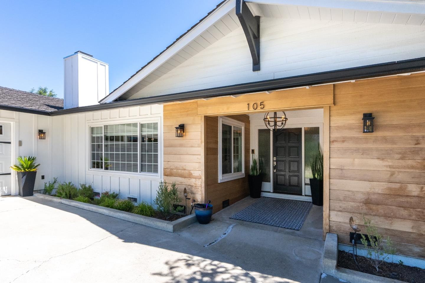 105 Rays Circle Hollister, CA 95023 - Photo 2 of 36 a front view of a building with potted plants