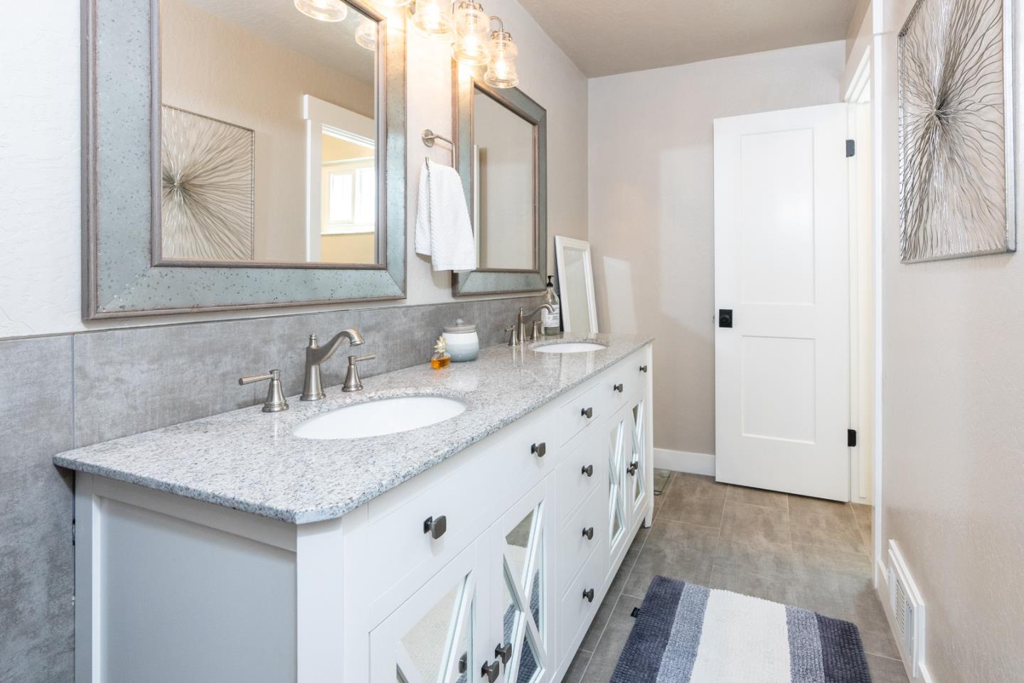 105 Rays Circle Hollister, CA 95023 - Photo 23 of 36 a bathroom with a granite countertop sink and a mirror