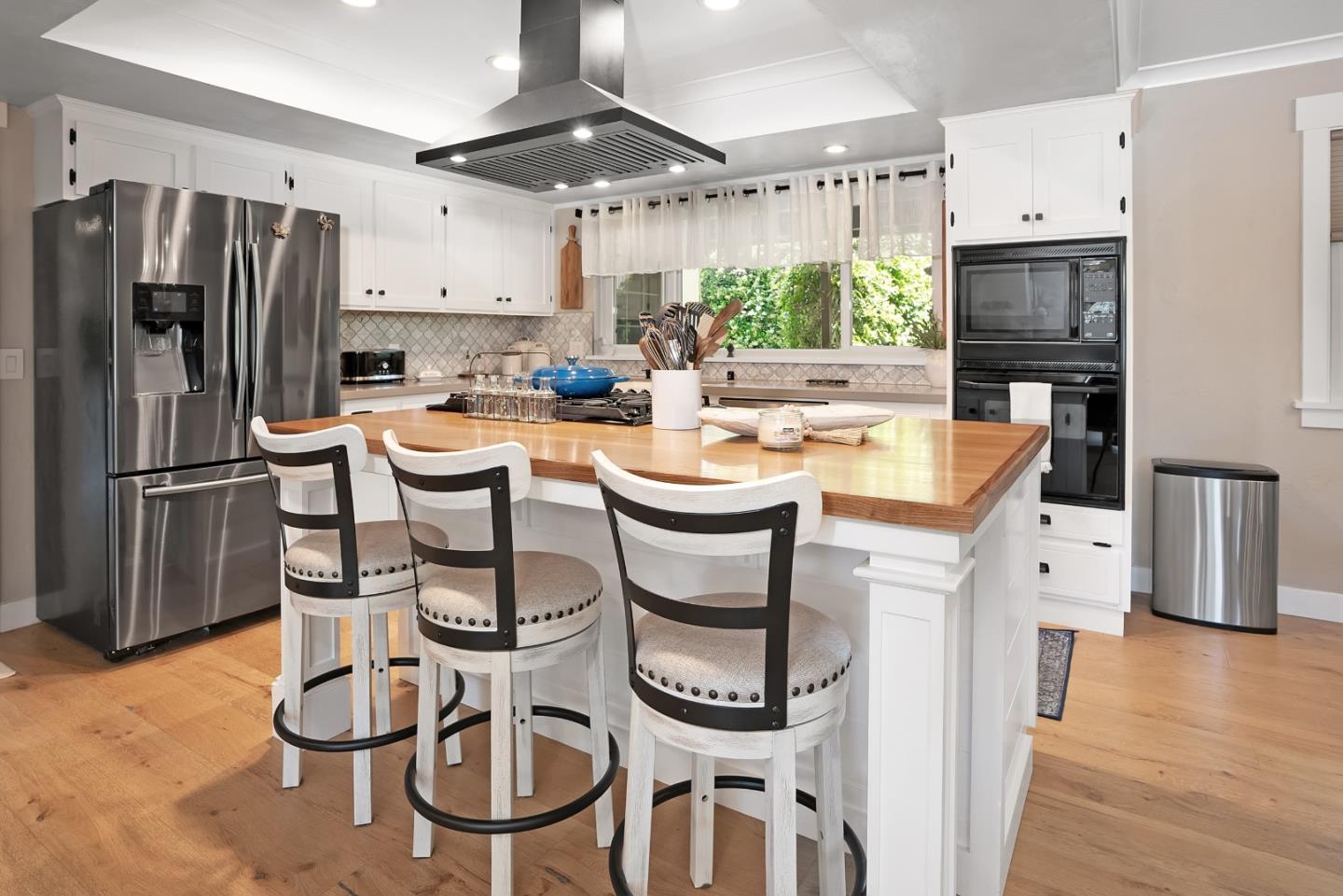 105 Rays Circle Hollister, CA 95023 - Photo 9 of 36 a kitchen with stainless steel appliances a table chairs and a refrigerator