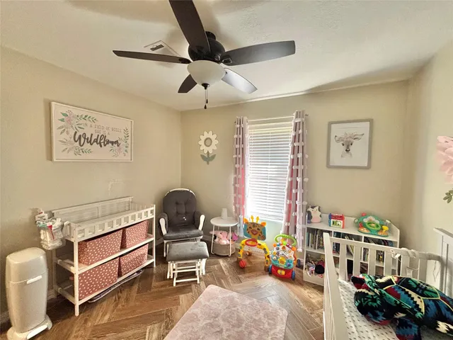 a bedroom with a baby bed baby crib and a dresser