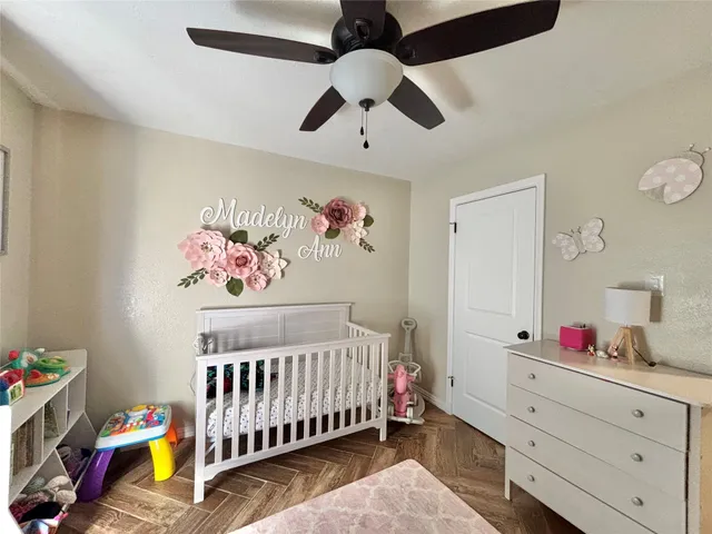 a bedroom with a bed and a ceiling fan