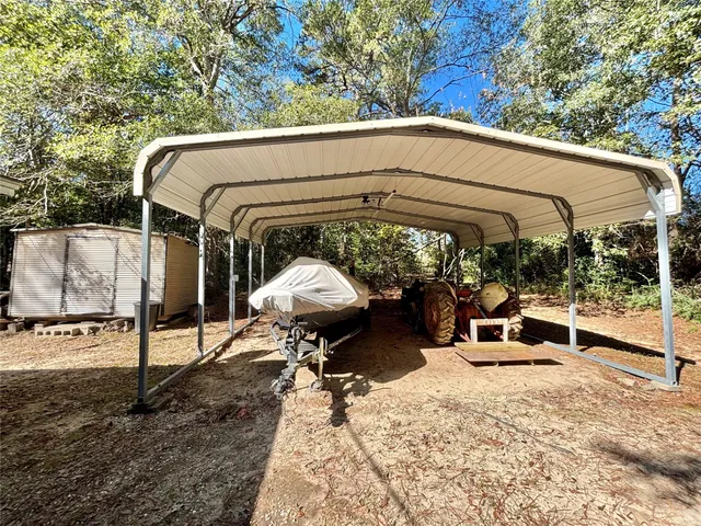 a view of a backyard with large trees