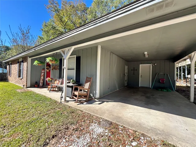 a view of a chairs and table in back of a building