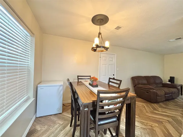 a view of a dining room with furniture and wooden floor