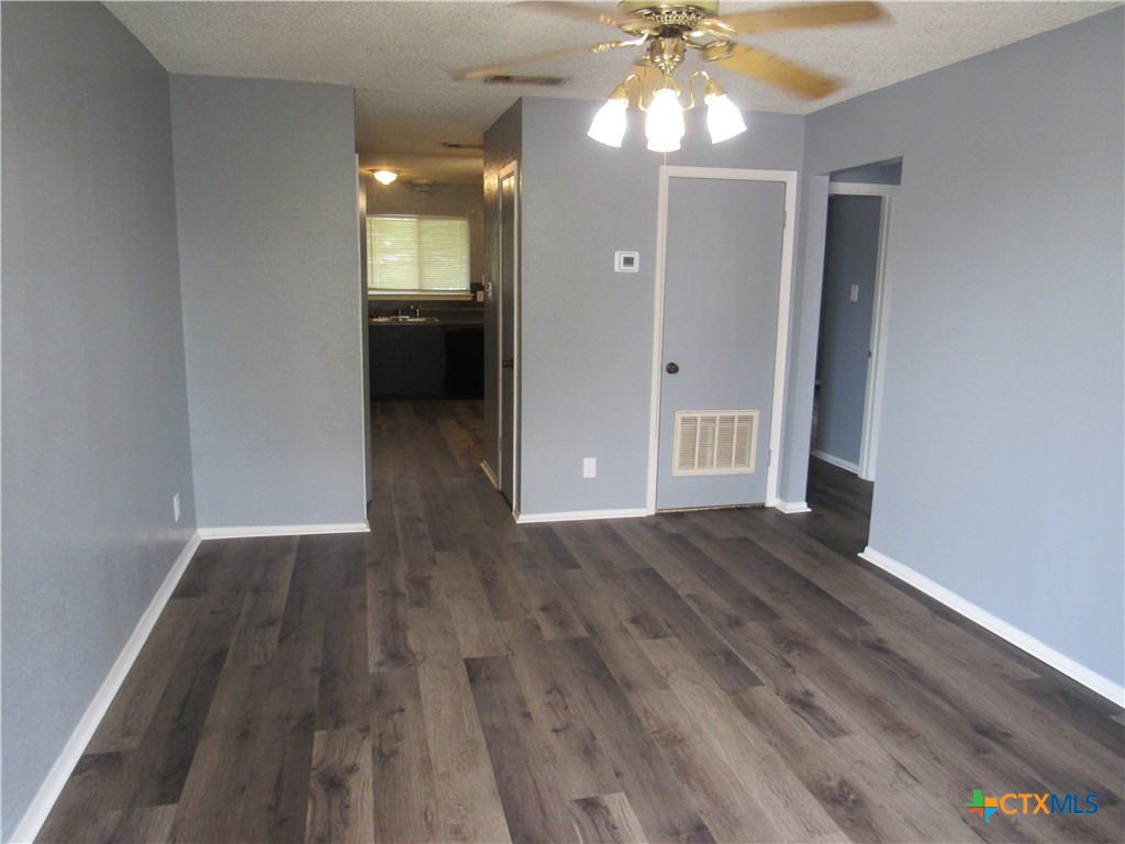 1301 Quail Circle, Unit D Killeen, TX 76549 - Photo 2 of 11 wooden floor in an empty room with a window
