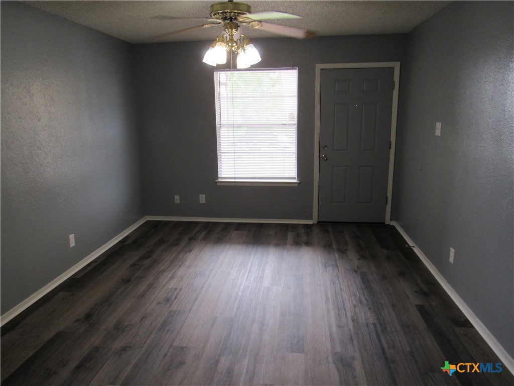 1301 Quail Circle, Unit D Killeen, TX 76549 - Photo 3 of 11 wooden floor in an empty room with a window