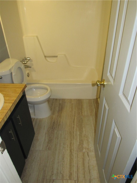 1301 Quail Circle, Unit D Killeen, TX 76549 - Photo 9 of 11 a bathroom with a granite countertop sink toilet and shower
