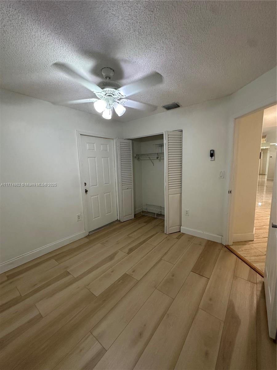 Westbrooke at Avalon Hialeah, FL 33015 - Photo 13 of 24 an empty room with closet and a ceiling fan