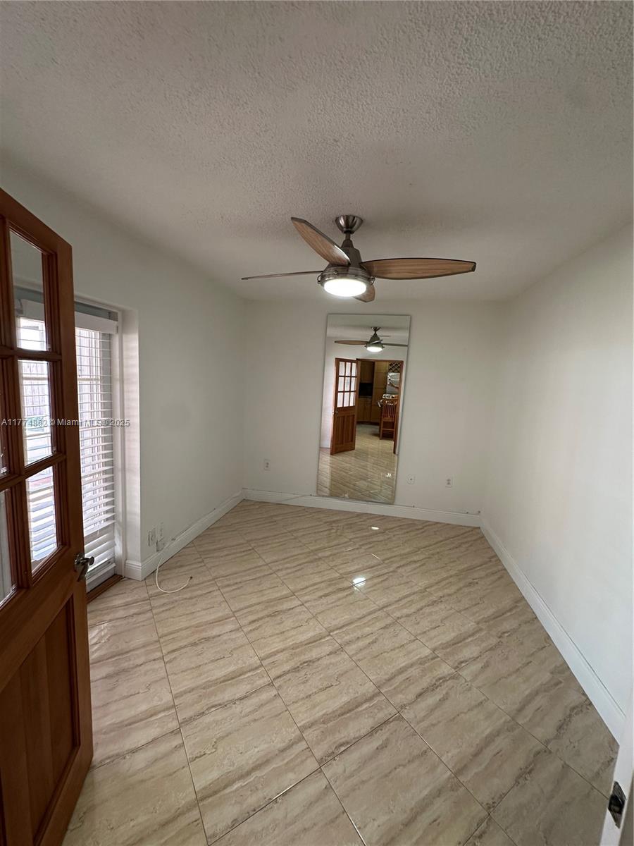 Westbrooke at Avalon Hialeah, FL 33015 - Photo 15 of 24 a view of empty room with wooden floor and fan