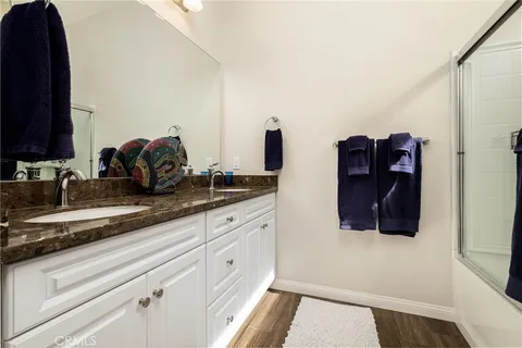 a kitchen with granite countertop a refrigerator and a sink