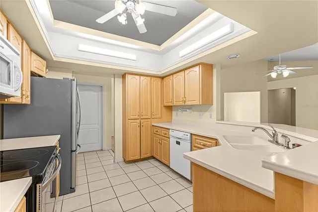 a kitchen with a sink appliances and cabinets