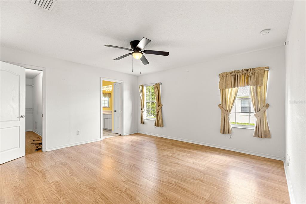 10884 Southwest 53rd Circle Ocala, FL 34476 - Photo 24 of 57 a view of empty room with wooden floor and fan
