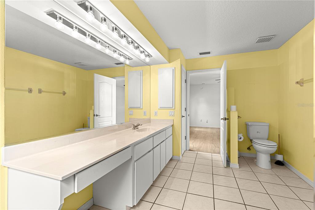 10884 Southwest 53rd Circle Ocala, FL 34476 - Photo 29 of 57 a bathroom with a sink a toilet and a shower