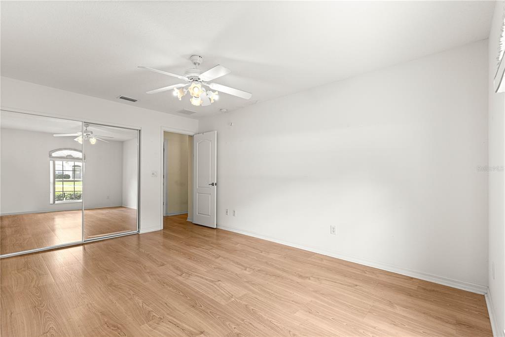10884 Southwest 53rd Circle Ocala, FL 34476 - Photo 35 of 57 wooden floor in an empty room with a window