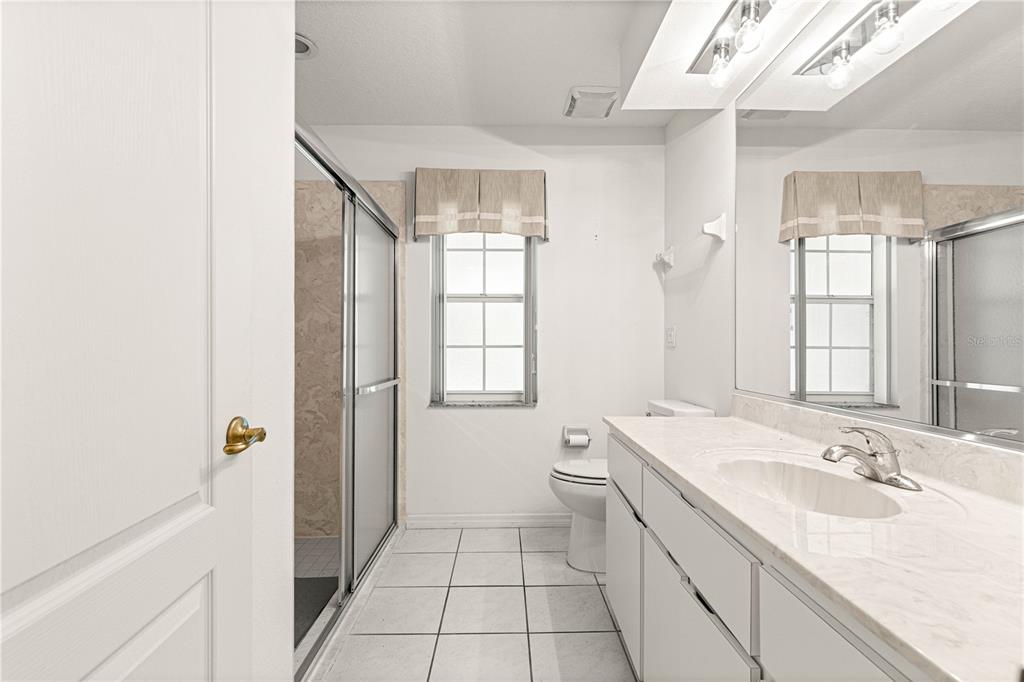 10884 Southwest 53rd Circle Ocala, FL 34476 - Photo 37 of 57 a bathroom with a sink a toilet and shower