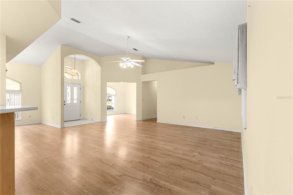 10884 Southwest 53rd Circle Ocala, FL 34476 - Photo 5 of 57 a view of an empty room with wooden floor