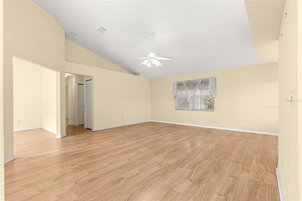 10884 Southwest 53rd Circle Ocala, FL 34476 - Photo 8 of 57 a view of an empty room with wooden floor and a window