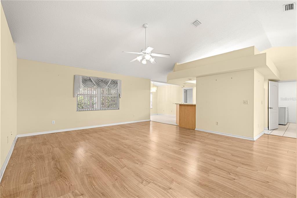 10884 Southwest 53rd Circle Ocala, FL 34476 - Photo 9 of 57 wooden floor in an empty room with a window