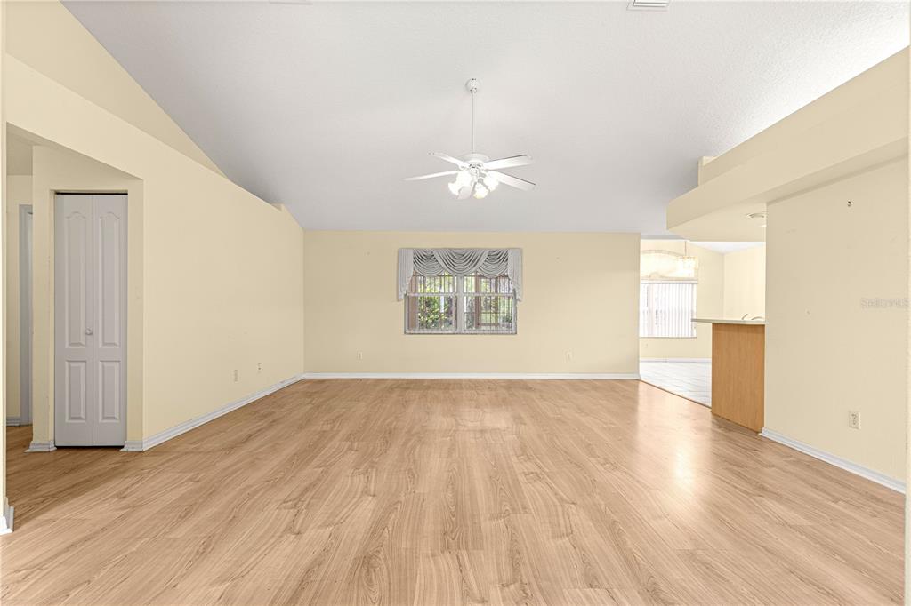 10884 Southwest 53rd Circle Ocala, FL 34476 - Photo 10 of 57 an empty room with wooden floor and windows