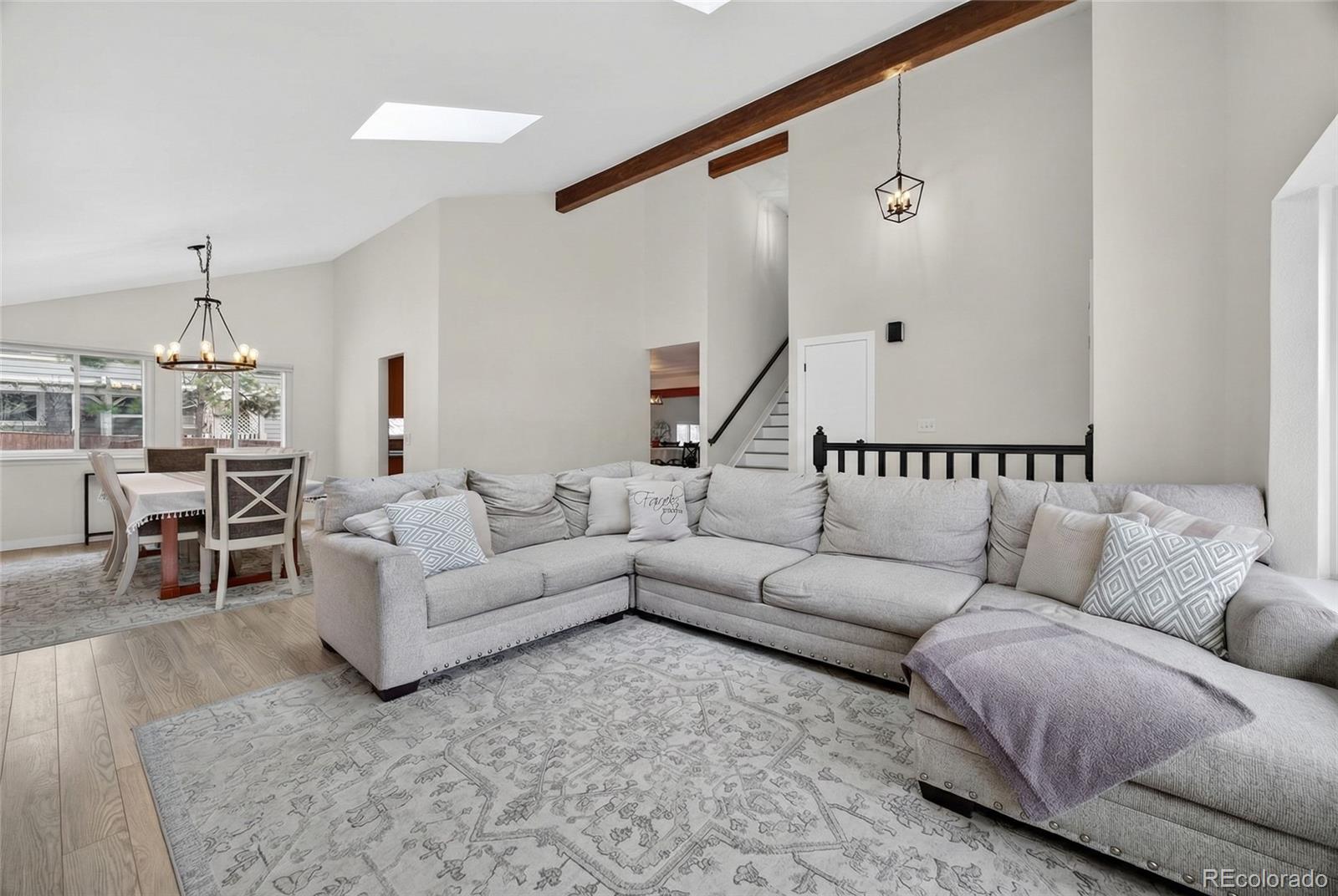 a living room with furniture and a chandelier