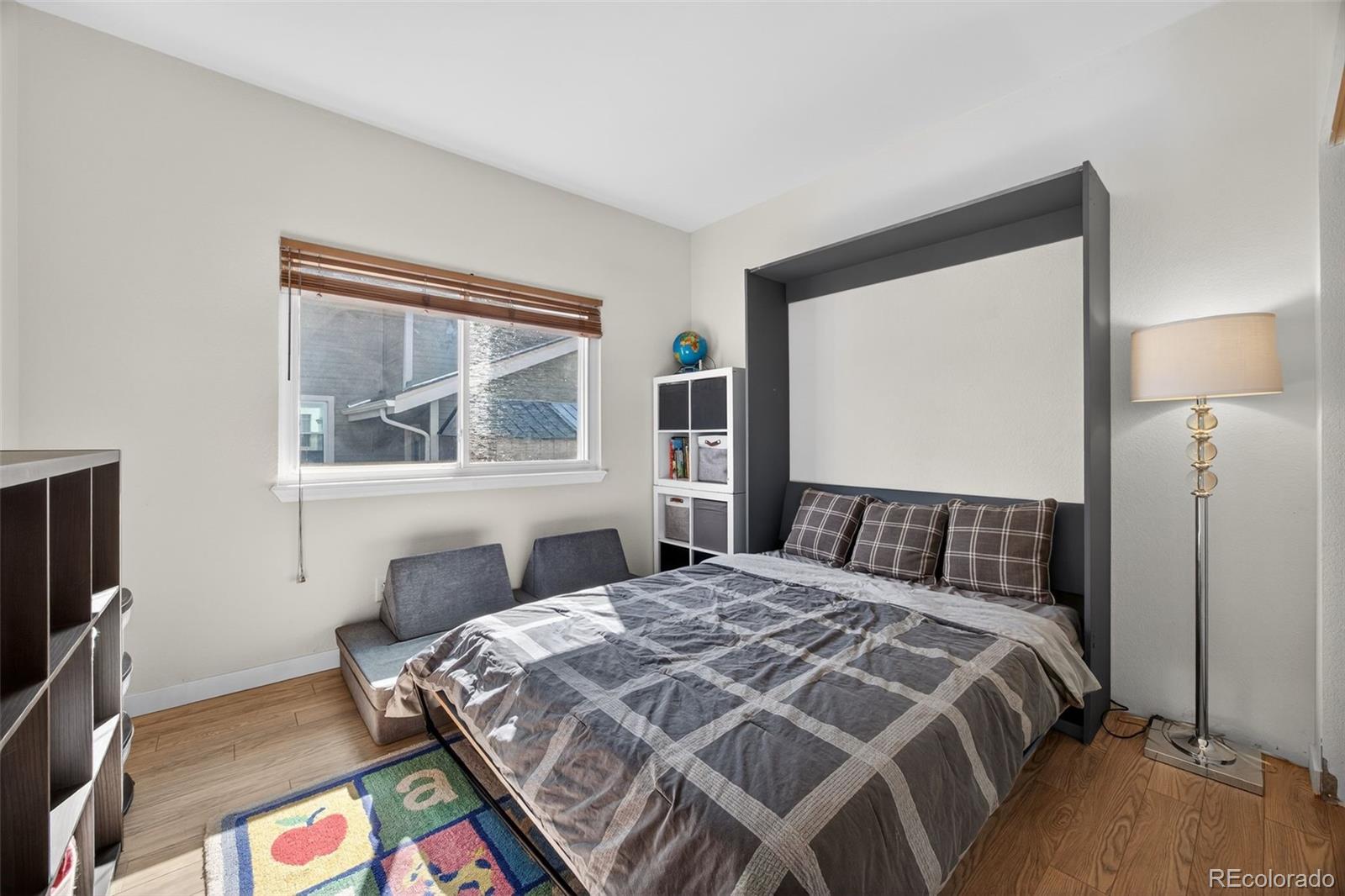 8764 Wildrose Court Highlands Ranch, CO 80126 - Photo 11 of 50 a bed sitting in a bedroom next to a window