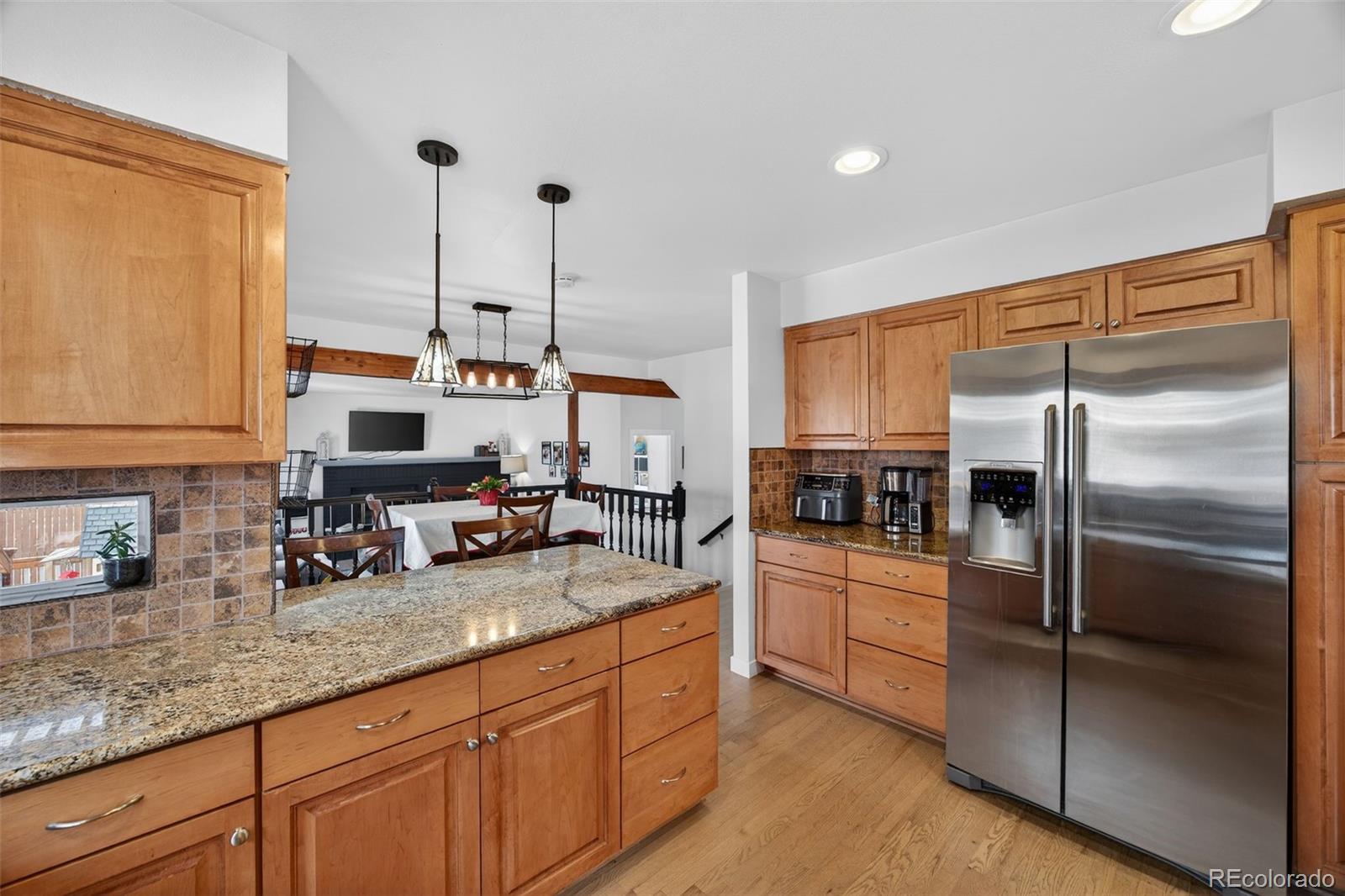 8764 Wildrose Court Highlands Ranch, CO 80126 - Photo 20 of 50 a kitchen with granite countertop stainless steel appliances and a counter space