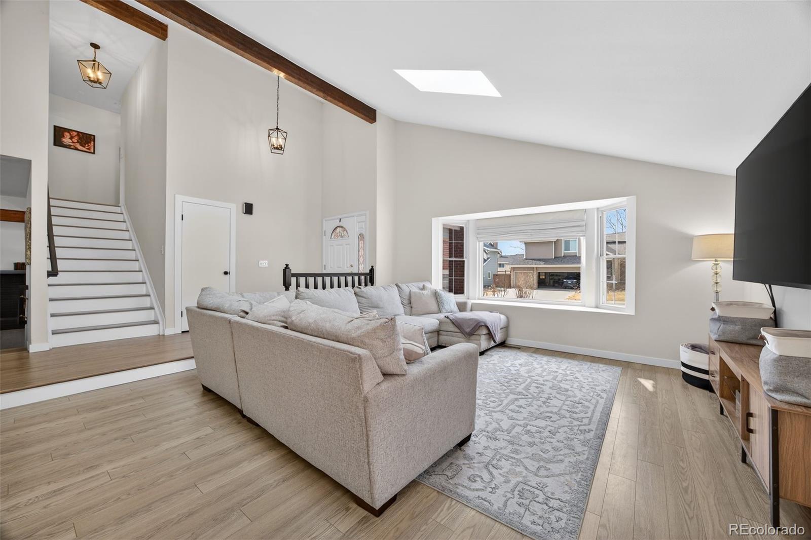 8764 Wildrose Court Highlands Ranch, CO 80126 - Photo 21 of 50 a living room with furniture and a wooden floor
