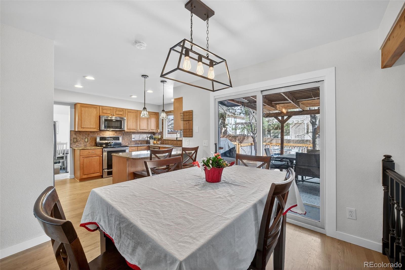 8764 Wildrose Court Highlands Ranch, CO 80126 - Photo 24 of 50 a kitchen with a dining table and chairs