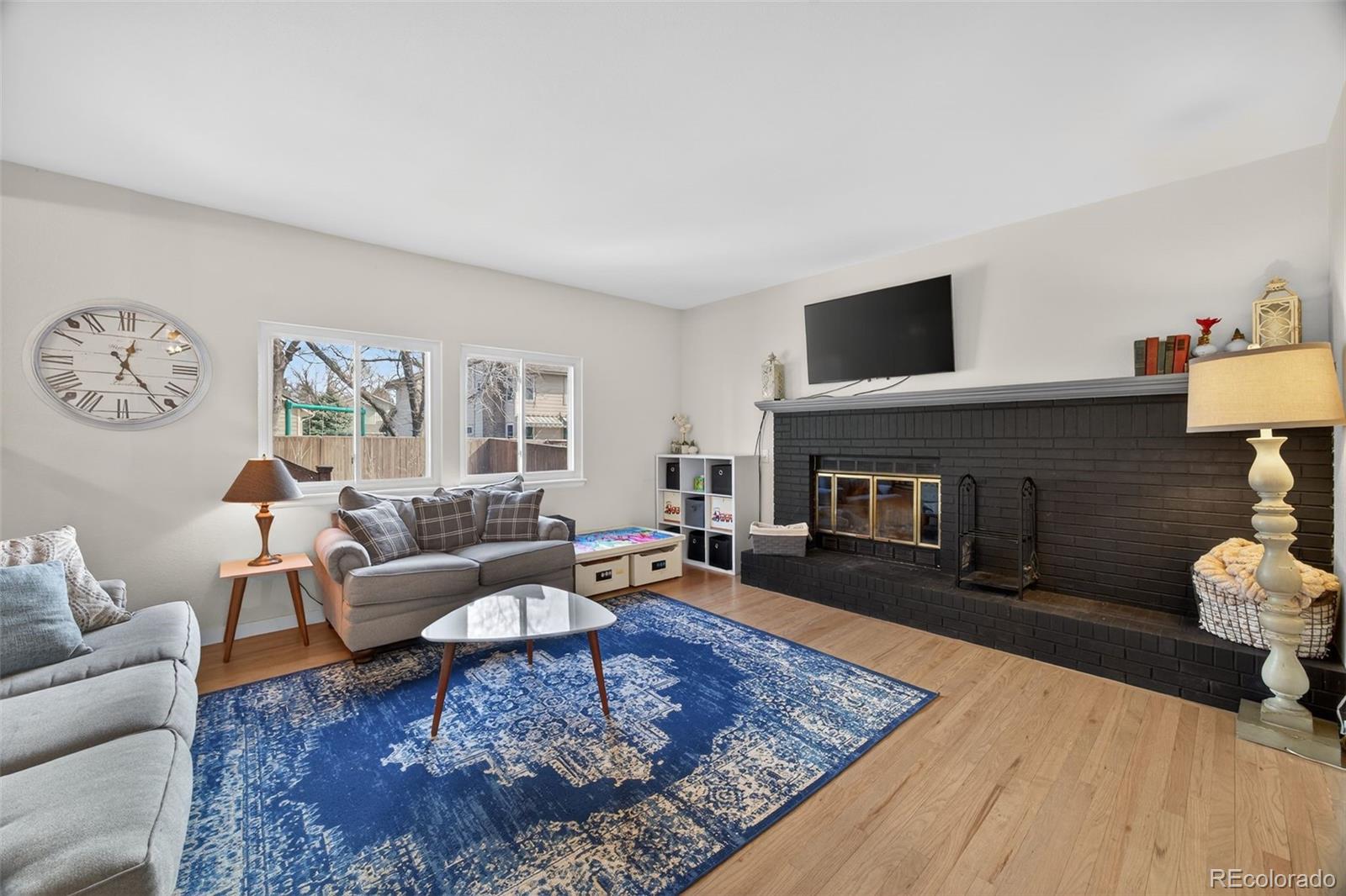 8764 Wildrose Court Highlands Ranch, CO 80126 - Photo 26 of 50 a living room with furniture and a fireplace