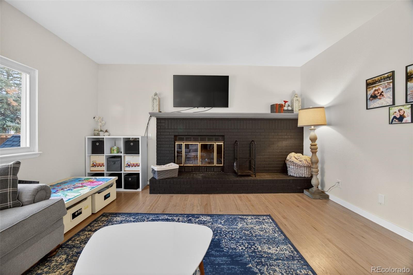 8764 Wildrose Court Highlands Ranch, CO 80126 - Photo 29 of 50 a living room with furniture and a flat screen tv
