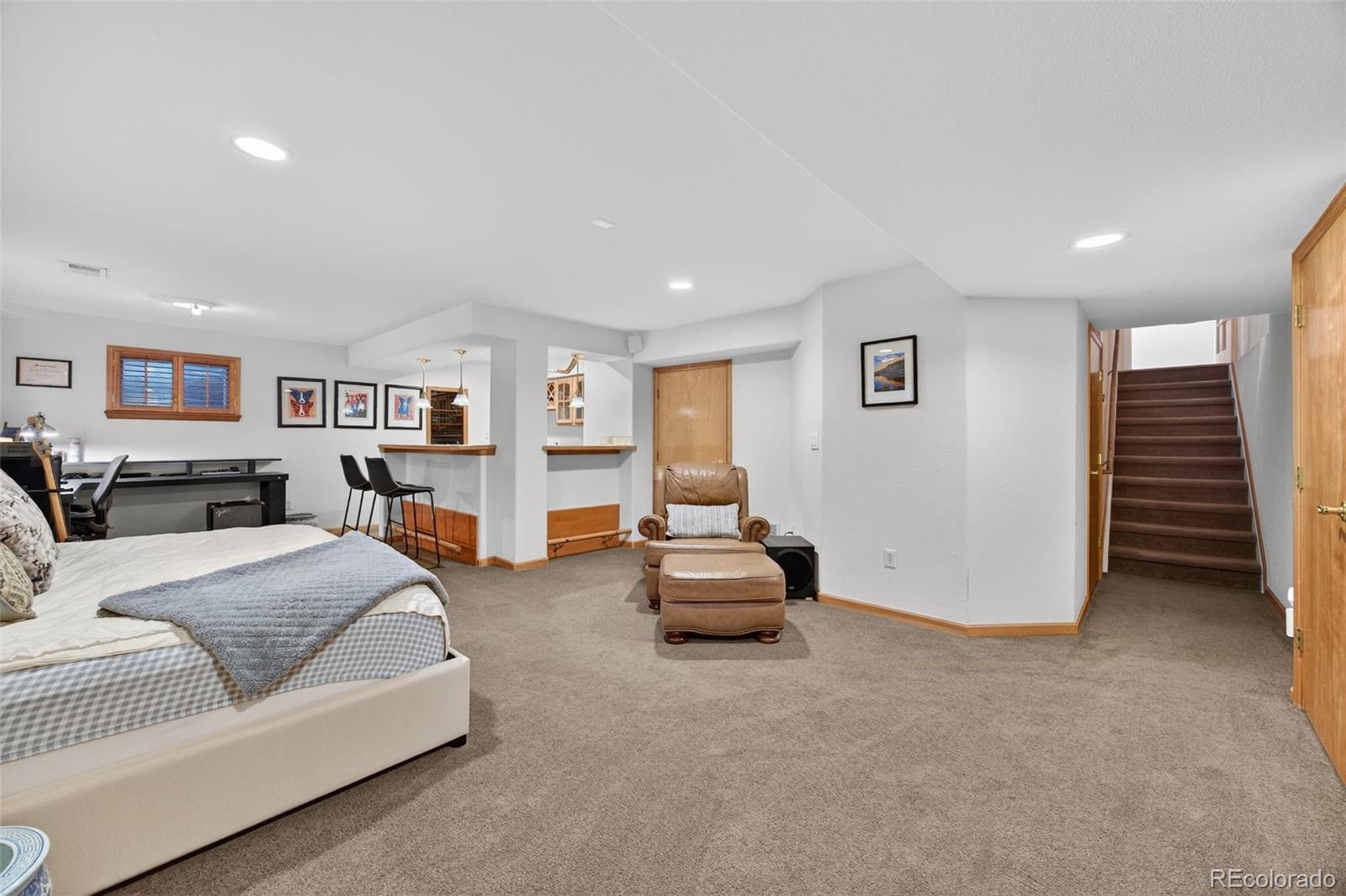 8764 Wildrose Court Highlands Ranch, CO 80126 - Photo 30 of 50 a spacious bedroom with a bed and a view of bedroom