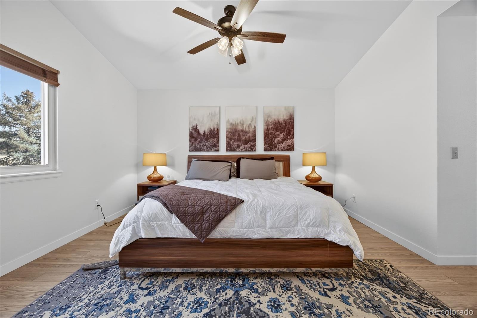 8764 Wildrose Court Highlands Ranch, CO 80126 - Photo 3 of 50 a bedroom with a bed and wooden floor