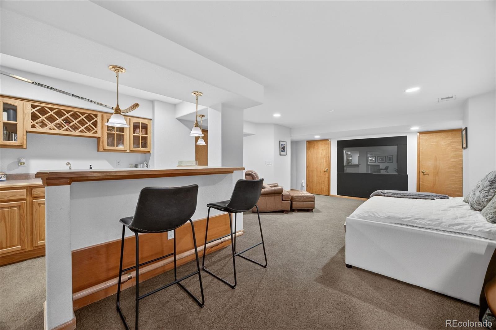 8764 Wildrose Court Highlands Ranch, CO 80126 - Photo 31 of 50 a living room with kitchen furniture and a table