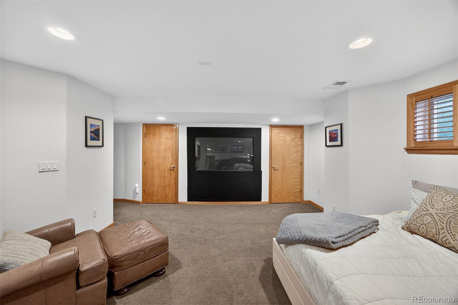 8764 Wildrose Court Highlands Ranch, CO 80126 - Photo 32 of 50 a bedroom with a bed and couch