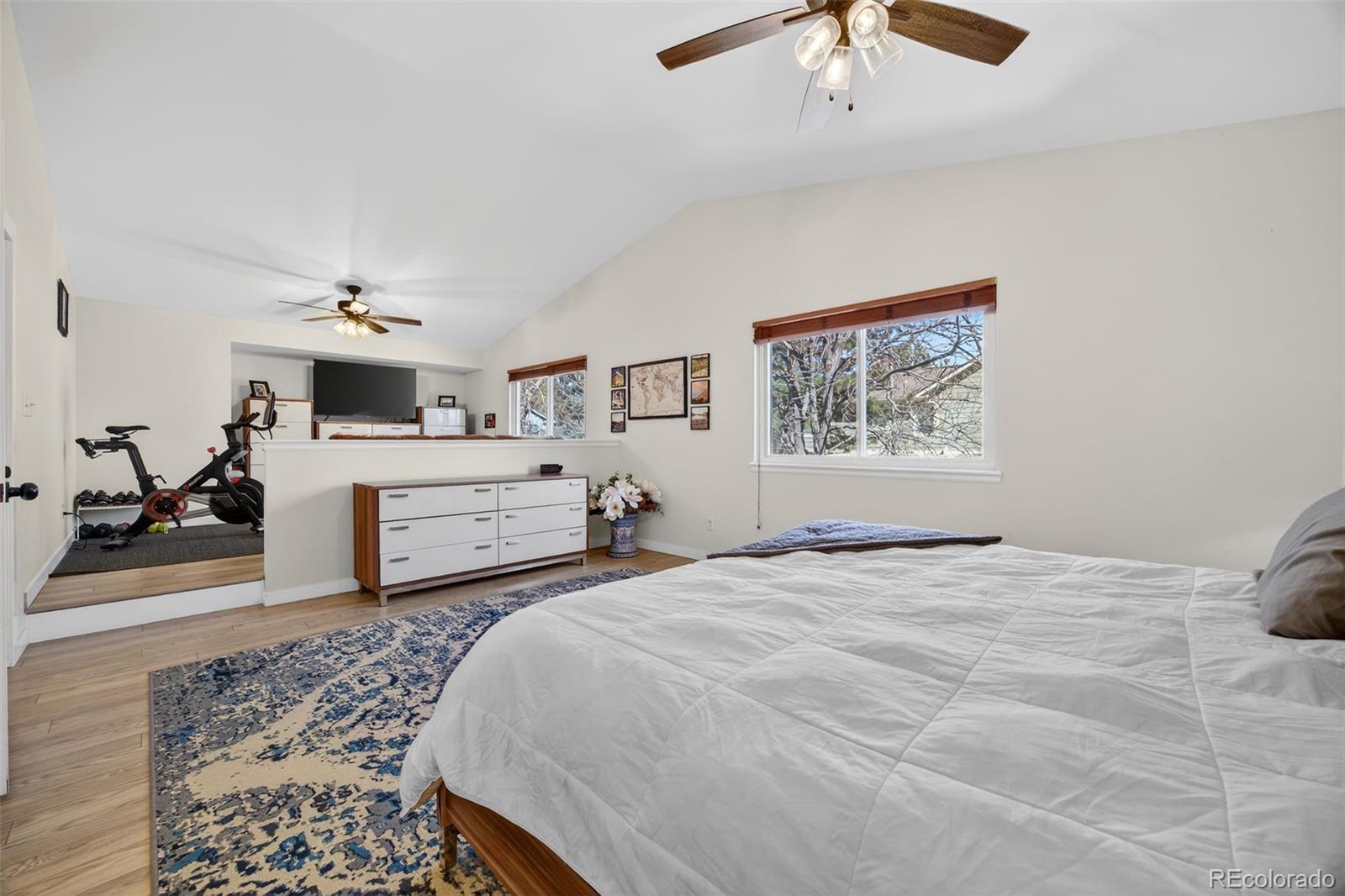 8764 Wildrose Court Highlands Ranch, CO 80126 - Photo 33 of 50 a bedroom with a large bed and a chandelier