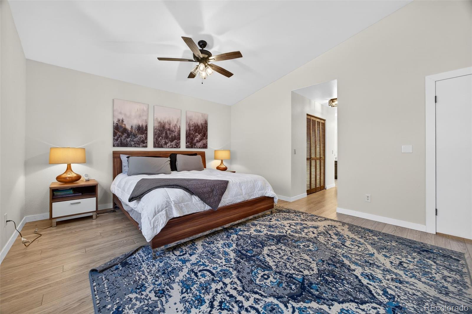 8764 Wildrose Court Highlands Ranch, CO 80126 - Photo 34 of 50 a bedroom with a bed and wooden floor