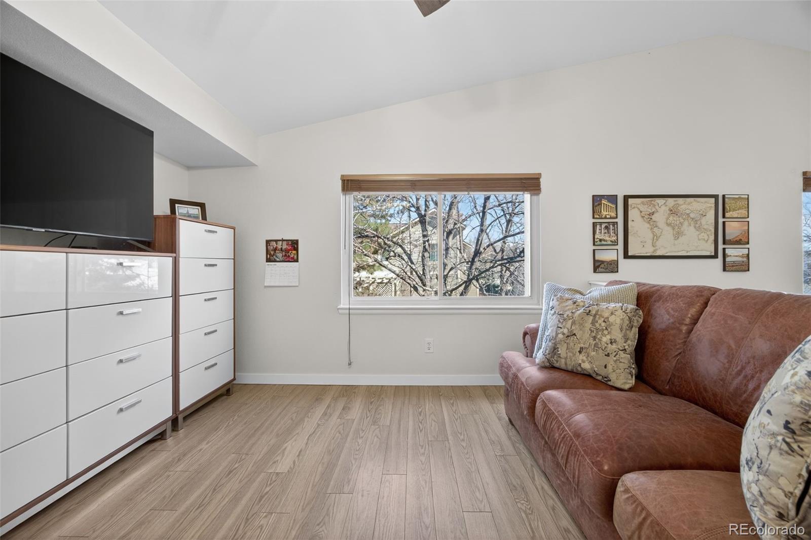 8764 Wildrose Court Highlands Ranch, CO 80126 - Photo 35 of 50 a living room with furniture and a flat screen tv