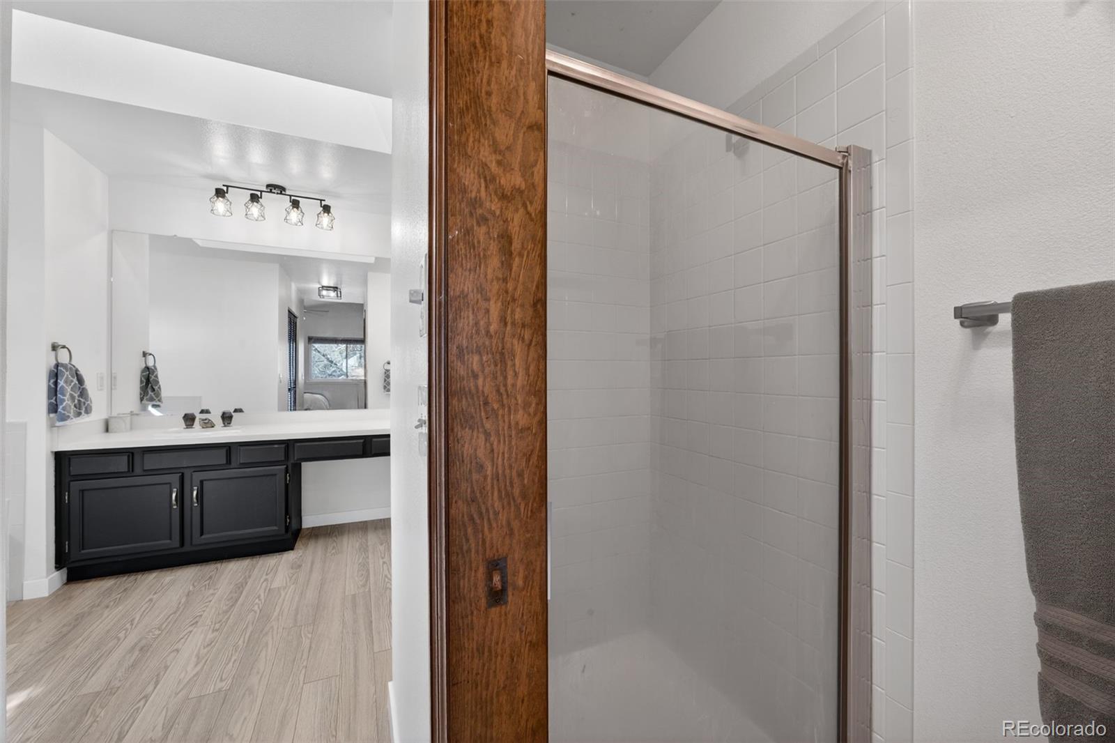 8764 Wildrose Court Highlands Ranch, CO 80126 - Photo 36 of 50 a en suite bathroom with a granite countertop sink and a mirror
