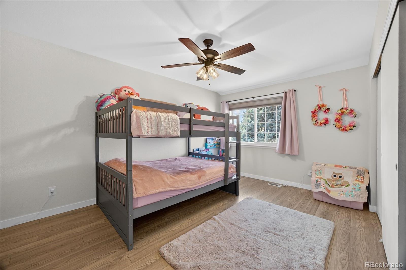 8764 Wildrose Court Highlands Ranch, CO 80126 - Photo 40 of 50 a bedroom with a bed and a window